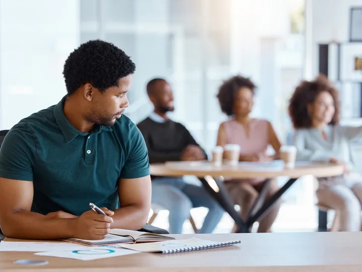 Man experiencing social anxiety, fear of judgment and discomfort around colleagues