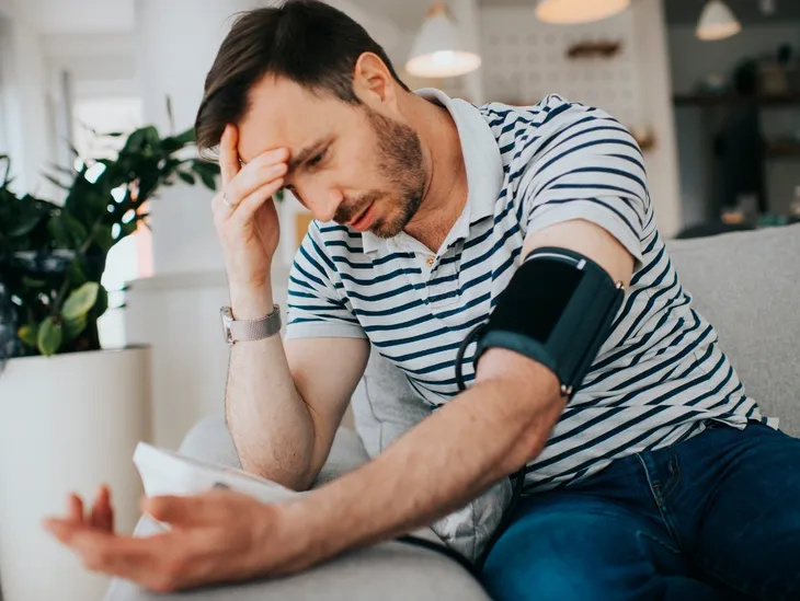 Person experiencing health anxiety and checking physical symptoms for reassurance